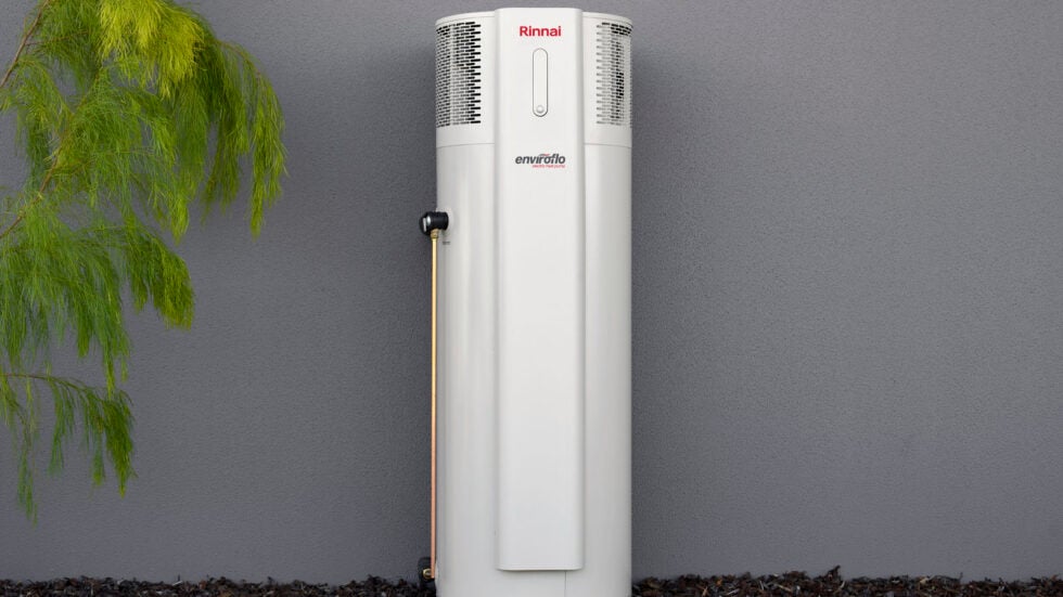 Heat pump hot water system installed beside a home