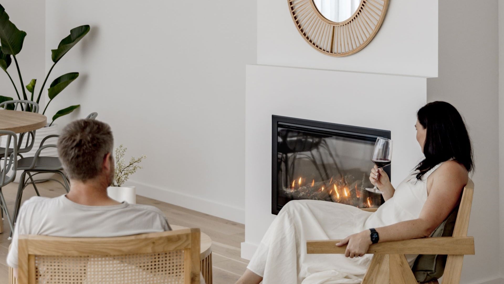 A couple relaxing beside an Escea gas fireplace