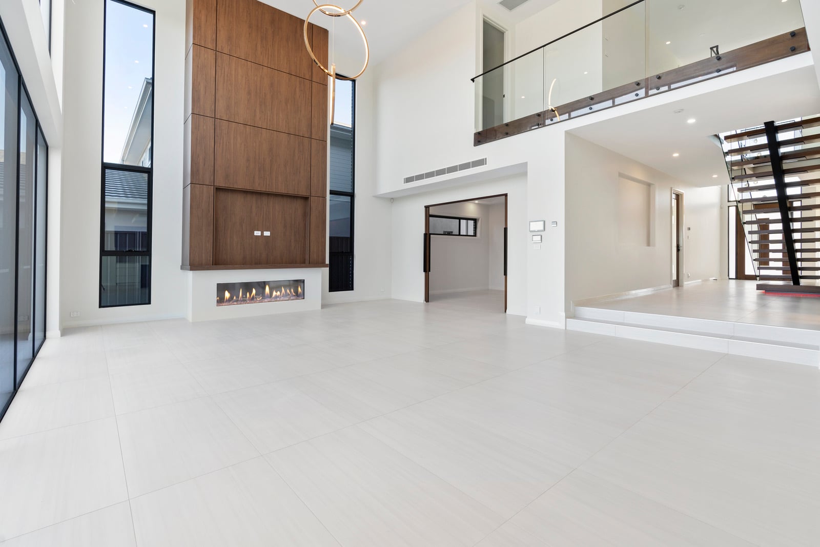 Living space with fireplace wall and mezzanine over, Oran Park