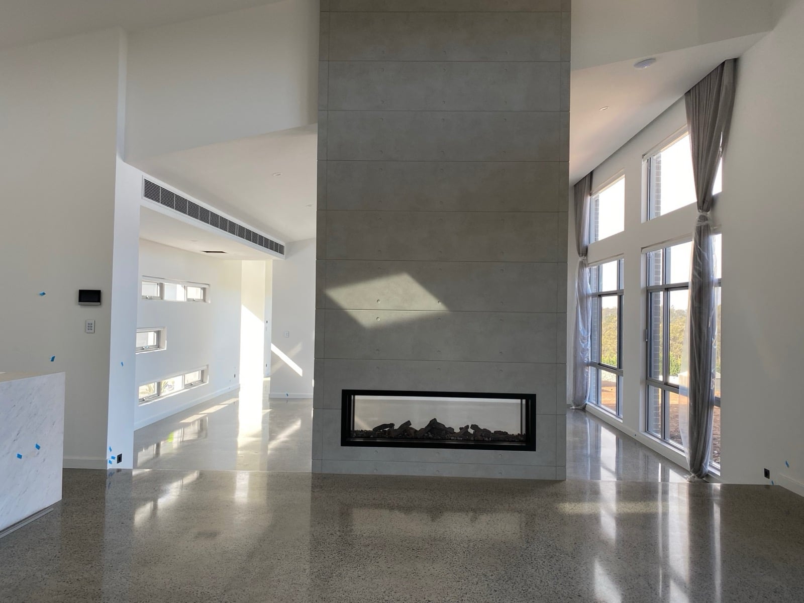 Renovated living space with gas fireplace and ducted air conditioning