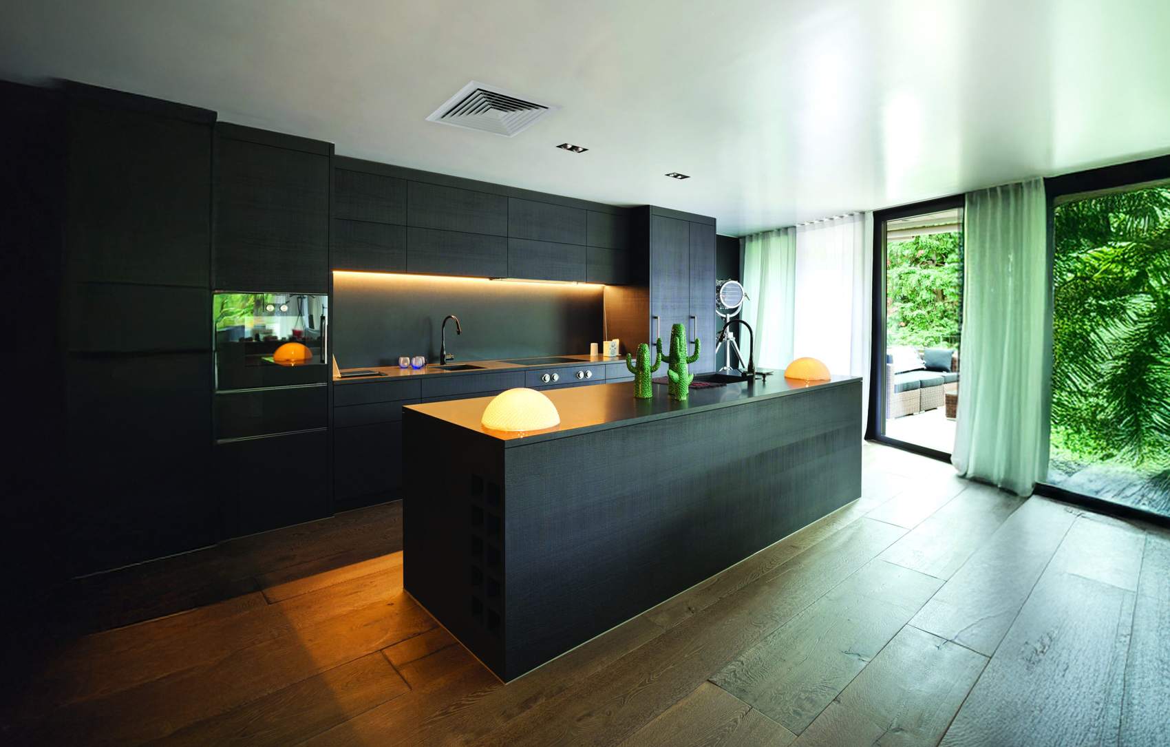 Modern black kitchen with a ceiling diffuser from whole-home ducted reverse cycle air conditioning