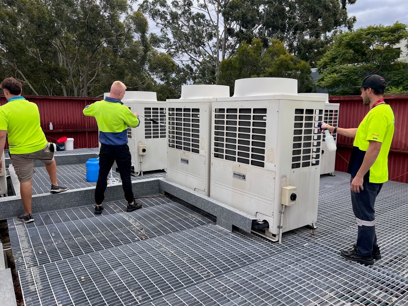 Ample Air technicians servicing rooftop commercial air conditioning plant