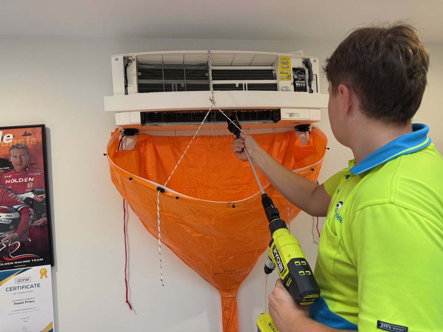 Ample Air technician servicing a split system air conditioner