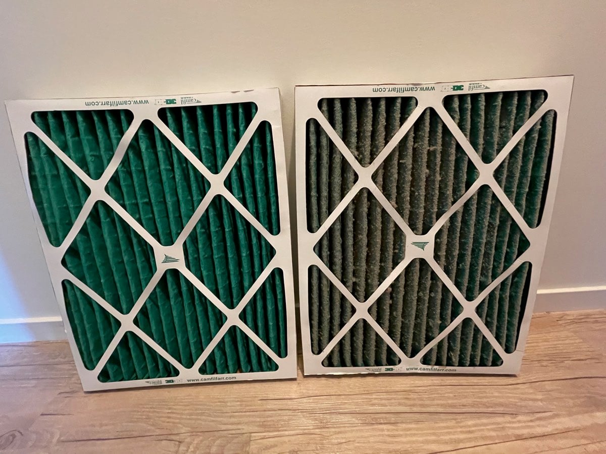 New air conditioning filter beside a dirty one after replacement