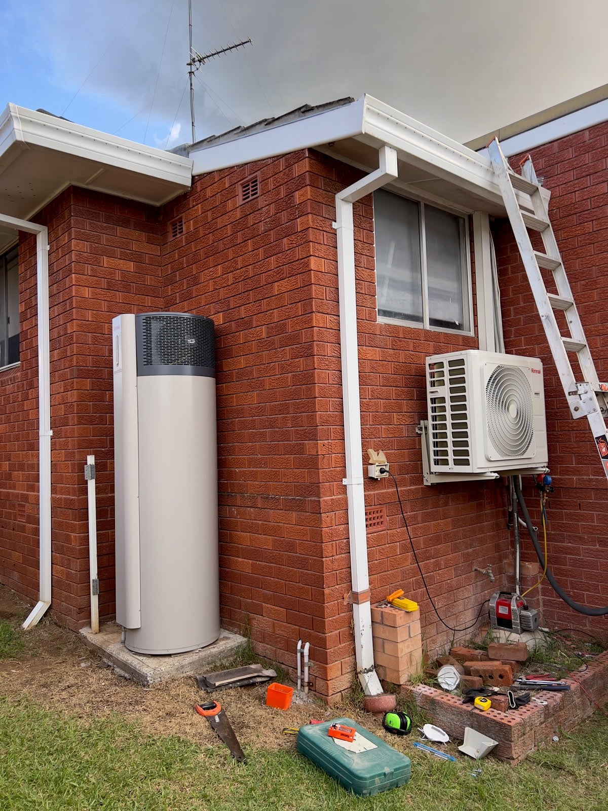 Rinnai heat pump hot water system and Rinnai ducted outdoor unit installed on the brick wall
