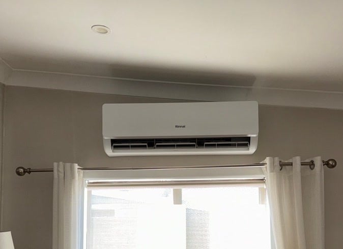 A wall-mounted split system installed above a window